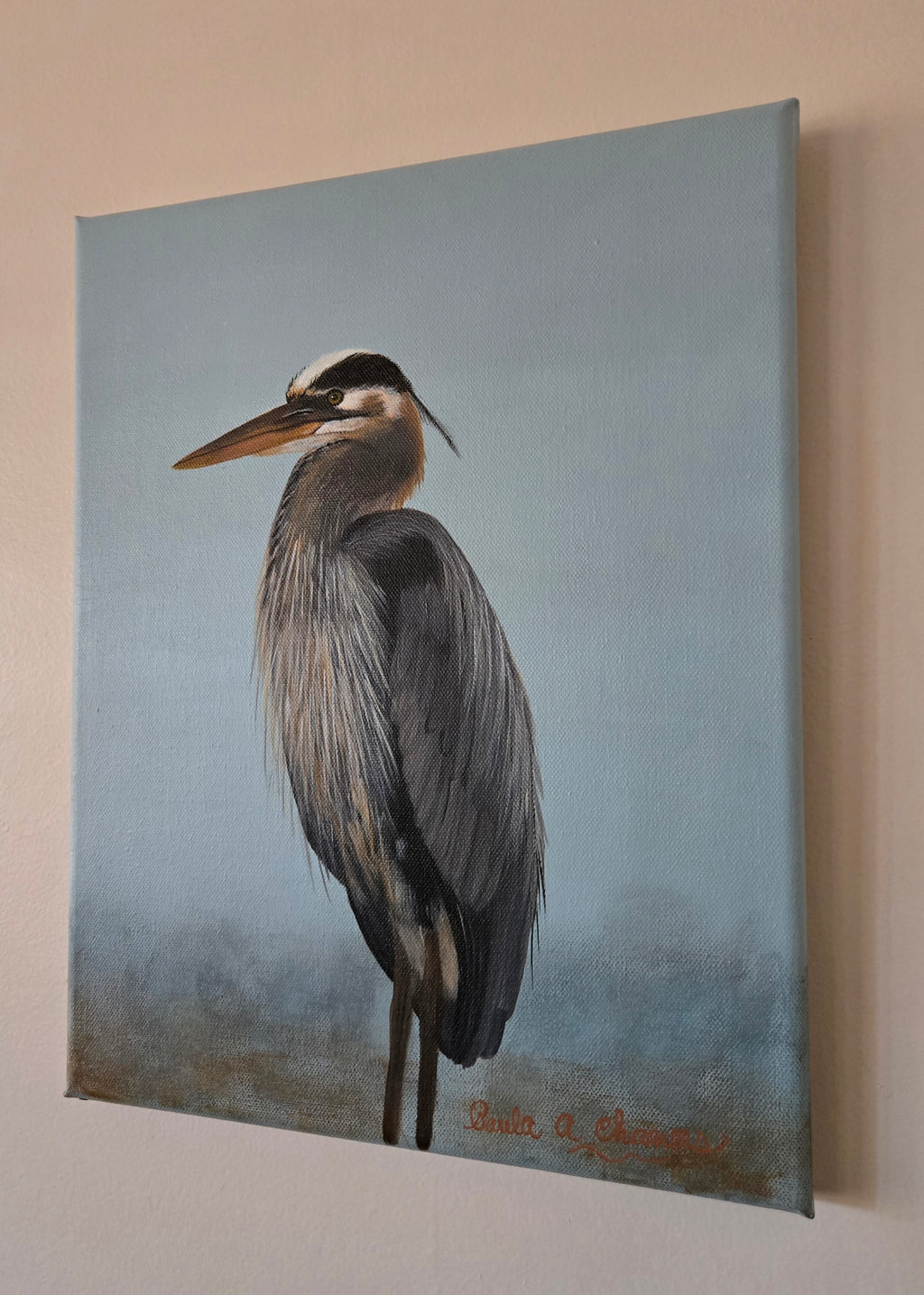 Blue heron standing in water acrylic painting titled 'Still Waters' by Paula A. Chavers, coastal bird wall art 11x14 for beach house decor.