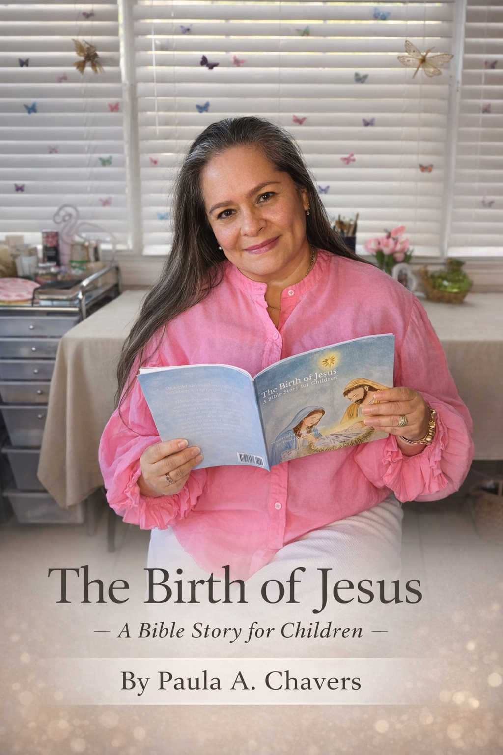 Author and illustrator Paula A. Chavers holding “The Birth of Jesus” Christian children’s book